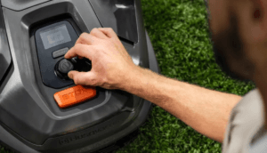 Person adjusting lawn mower settings